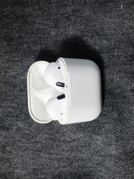 Closeup white true wireless stereo earbuds in case isolated on black background. Stock Photos
