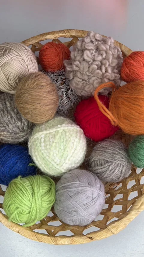Closeup wicker basket with woolen balls of yarn for hand knitting and crocheting Stock Footage 306561107