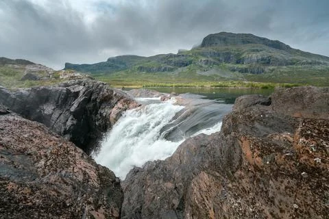 Closeup, wide, low angle shot of mighty Stuor Muorkkegarttje waterfall on Stock Photos