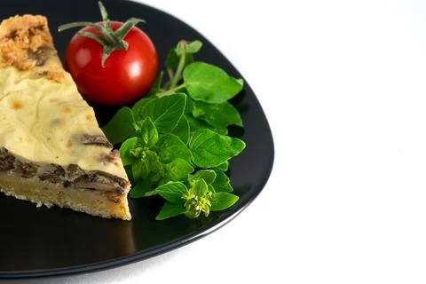 Closeup wide studio shot of a slice of yellow French salty cake, or quiche, with Stock Photos