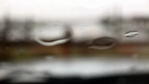 Closeup on windshield as rain falls Stock Footage 100611379