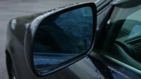 Closeup of wing mirror. Raindrops on car window and rear view mirror. Stock Footage 106837862