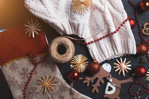 Closeup of winter flat lay of handmade wooden deer, toys, red balls, beads, C Stock Photos