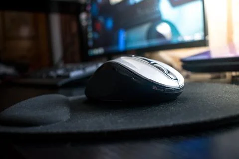 Closeup of Wireless Bluetooth computer mouse on a black desk with mouse pad Stock Photos