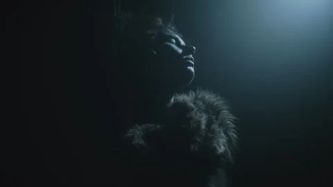 Closeup of a witch performing a ritual dance under the spotlight Video stock 259859694