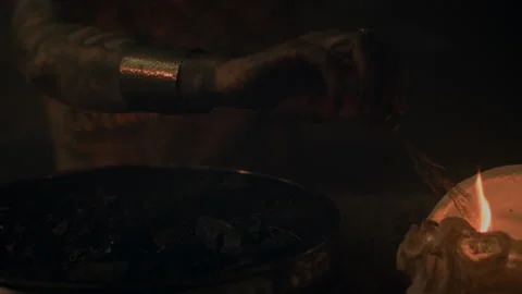 Closeup of a Witch who puts a flame to make a voodoo mixture Stock Footage 259860343
