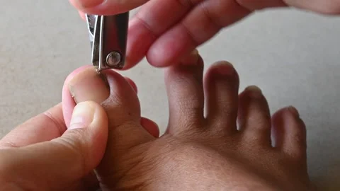 Closeup of a woman cutting nails by nail clipper. Stock Footage 253701853