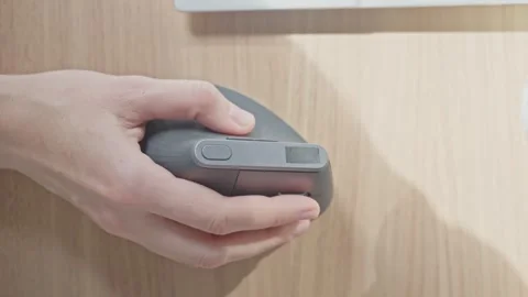 Closeup of woman hand using computer mouse on wooden desk surface Stock Footage 331750995