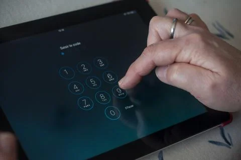 Closeup of woman hands on identification code page on tablet Foto stock