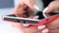 Closeup of woman hands with red smartphone. Woman typing sms on her cell phone HD Footage
