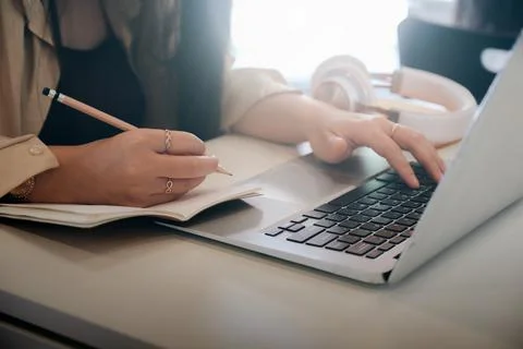 Closeup woman hands using computer laptop. Stock Photos