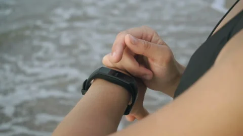 Closeup Of Woman Hands Using Smartwatch After Workout At Sunset On Beach. Stock Footage 112419722