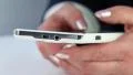 Closeup of woman hands with white cell phone. Woman typing sms on her smartphone HD Footage