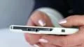 Closeup of woman hands with white cell phone. Woman types sms on her smartphone HD Footage