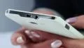 Closeup of woman hands with white cell phone. Woman types sms on her smartphone HD Footage