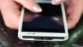 Closeup of woman hands with white smartphone. Woman typing sms on her cell phone HD Footage