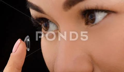Closeup of woman putting contact lenses Stock Photos