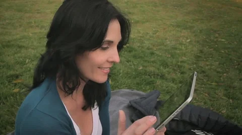 Closeup woman reading tablet computer in park Video stock 22024958