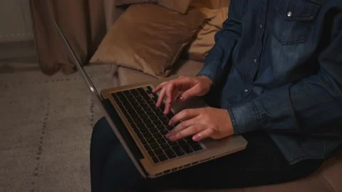 Closeup of woman sitting on couch using laptop typing message, lady chatting on Stock Footage 151161279