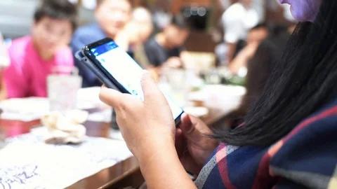 Closeup woman using and texting chat on mobile phone during eating dinner  Stock Footage 112380919