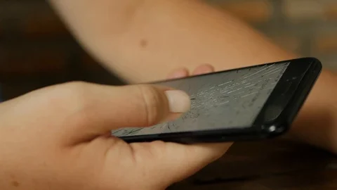 Closeup of a woman using a broken mobile phone smartphone. Mobile screen smashed Stock Footage 117226062