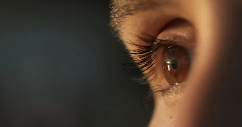 Closeup of woman's blinking brown eye on blur background, side view. Stock Footage 112044549