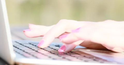Closeup of woman's finger typing on a computer outdoors Stock Footage 89598196