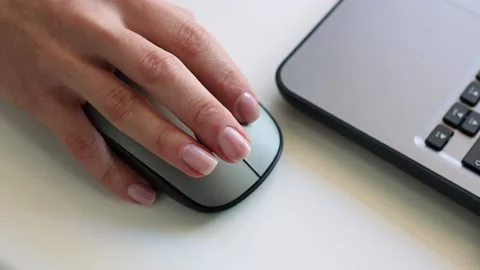 Closeup of woman's hand holding computer mouse. Stockbeeldmateriaal 150236169