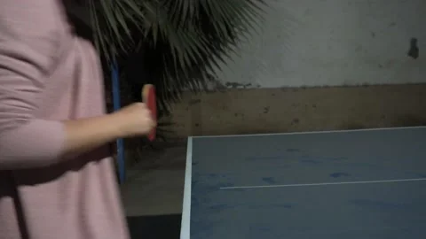 Closeup of a woman's hand holding a ping pong racket and hitting the ball at a Video stock 170013779