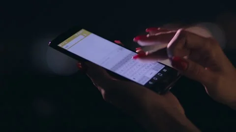 Closeup woman's hand texting on cellphone at night Stock Footage 65014166