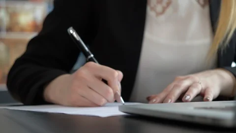 Closeup of woman's hand writing on paper Stock Footage