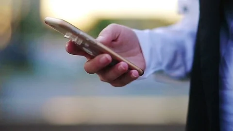 Closeup of woman's hands browsing with a cityscape at the background Stock Footage 76697125