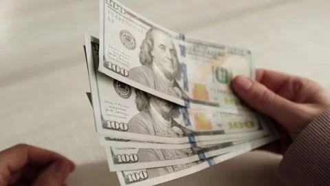 Closeup of woman's hands counting dollar cash banknotes. Woman calculates money Stock Footage 318897358