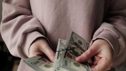 Closeup of woman's hands counting dollar cash banknotes. Stock Footage 318897949