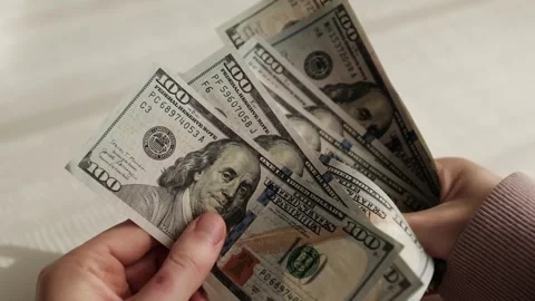 Closeup of woman's hands counting dollar cash banknotes. Stock Footage 318897950