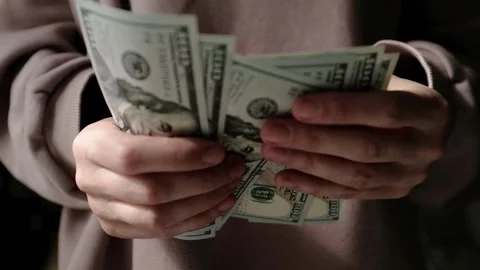 Closeup of woman's hands counting dollar cash banknotes. Stock Footage 318897962