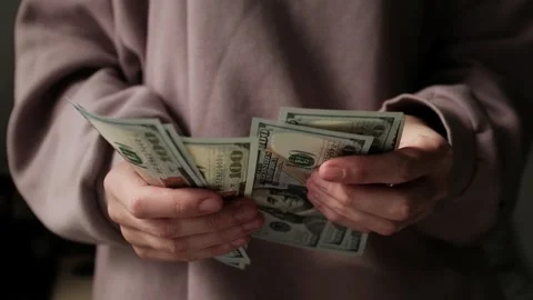 Closeup of woman's hands counting dollar cash banknotes. Stock Footage 318898054