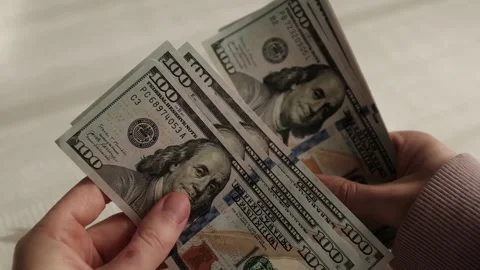 Closeup of woman's hands counting dollar cash banknotes. Stock Footage 318898166