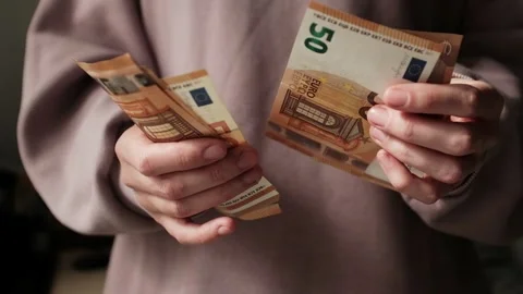 Closeup of woman's hands counting Euro cash banknotes. Woman calculates income Stock Footage 318898160