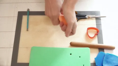 Closeup of woman's hands creating flower decoration for a cake Stock Footage 74583972