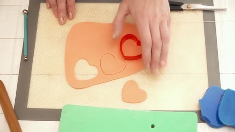 Closeup of woman's hands creating flower decoration for a tasty cake Stock Footage 74584102