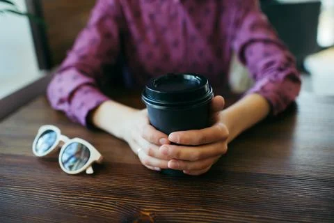 Closeup of woman's hands with cup of coffee. Stock Photos