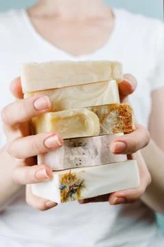 Closeup of woman's hands holding a stack of natural handmade soap, selective  스톡 사진