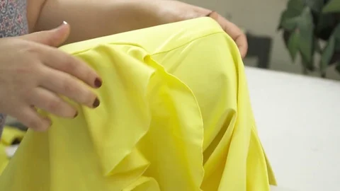 Closeup of woman's hands ironing the dress slow motion Stock Footage