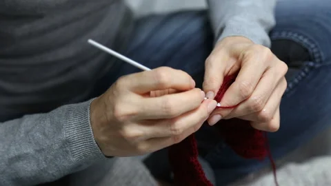 Closeup womans hands knitting red burgundy wool yarn. Stock Footage 96170095