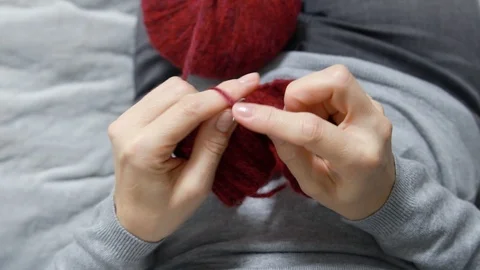 Closeup womans hands knitting red burgundy wool yarn. Stock Footage 127295360