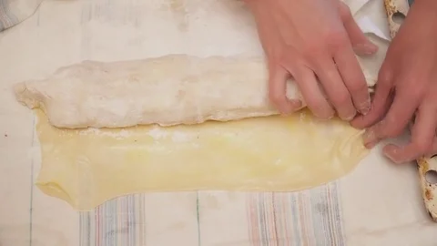 Closeup of woman's hands rolling the strudel Stock Footage 74464242