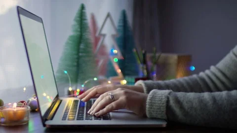 Closeup Of Woman's Hands, She Uses Her Laptop At Home, Decorated For Christmas Stock Footage 82334947