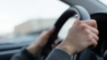 Closeup Of Woman's Hands On Steering Wheel, As She Drives Downtown Stock Footage 85769165