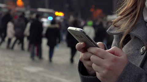 Closeup woman's hands texting on the mobile phone in the city at the dusk Stock Footage 59958447
